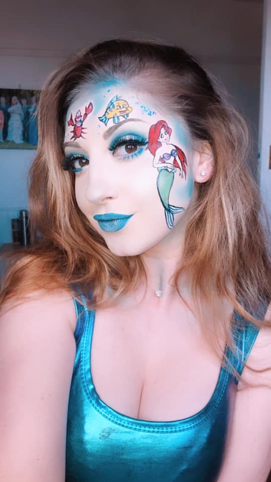 woman with Disney's ariel painted on her face