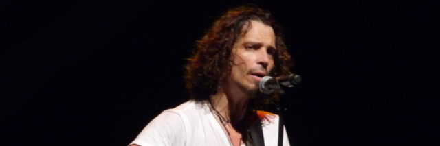 Chris Cornell sings and plays his guitar onstage