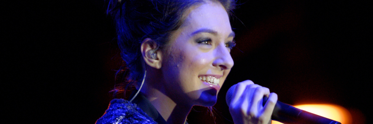 Christina Grimmie Remembered By Rare Disease Community Christina Grimmie sings onstage in a sparkly outfit