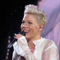 Pink performs onstage in a white outfit