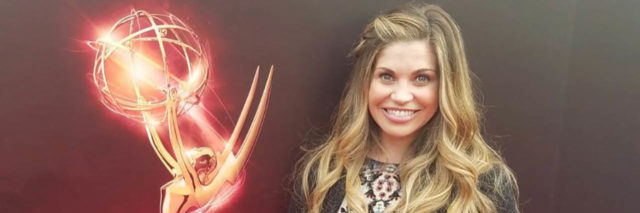 Danielle Fishel poses in a gown while on the red carpet