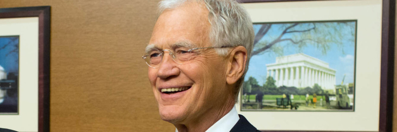 David Letterman smiles while at the White House.