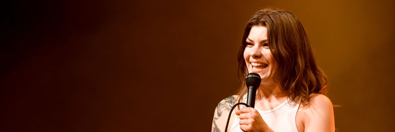 Donna Missal Shares Vulnerable Selfie to Show Skin Picking and Anxiety Singer Donna Missal singers onstage while wearing a white jumpsuit