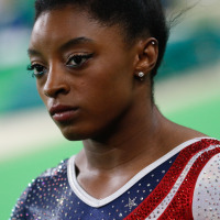 Simone Biles looks serious before she performs a routine at the Olympics