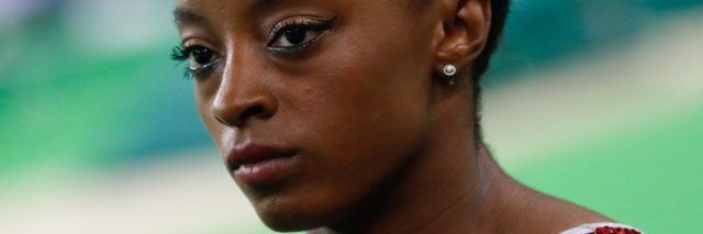 Simone Biles looks serious before she performs a routine at the Olympics