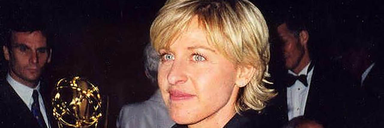 Ellen DeGeneres accepts an Emmy in a black suit