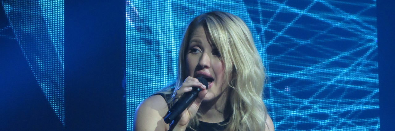 Ellie Goulding performs onstage in a black outfit