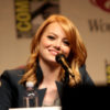 Emma Stone smiles at the audience while on a panel.
