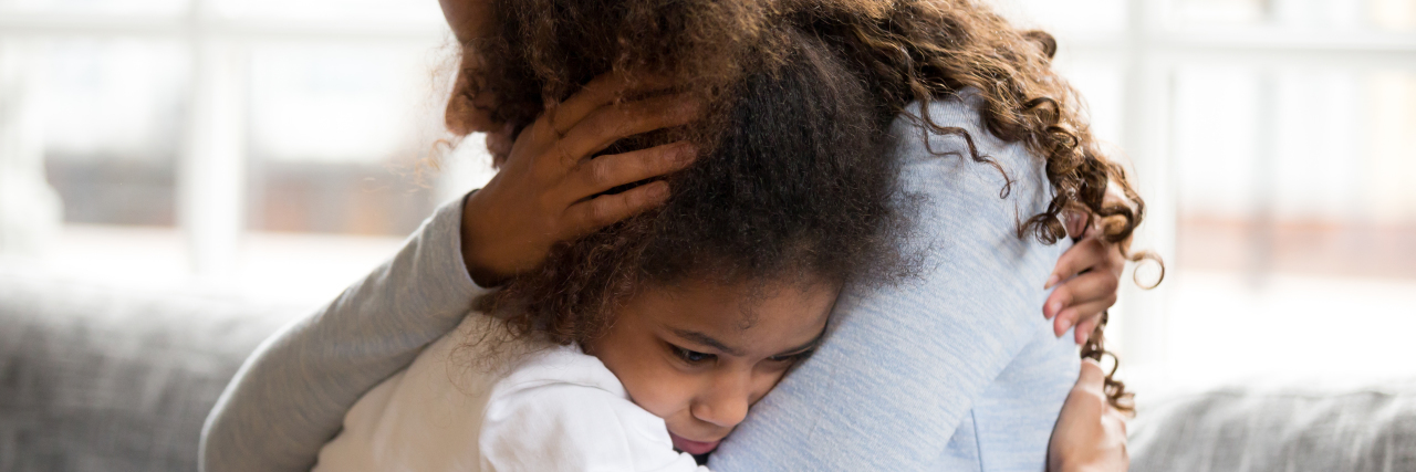 Helping Children Cope With Anxiety During the COVID-19 Pandemic Mother embracing sad daughter.