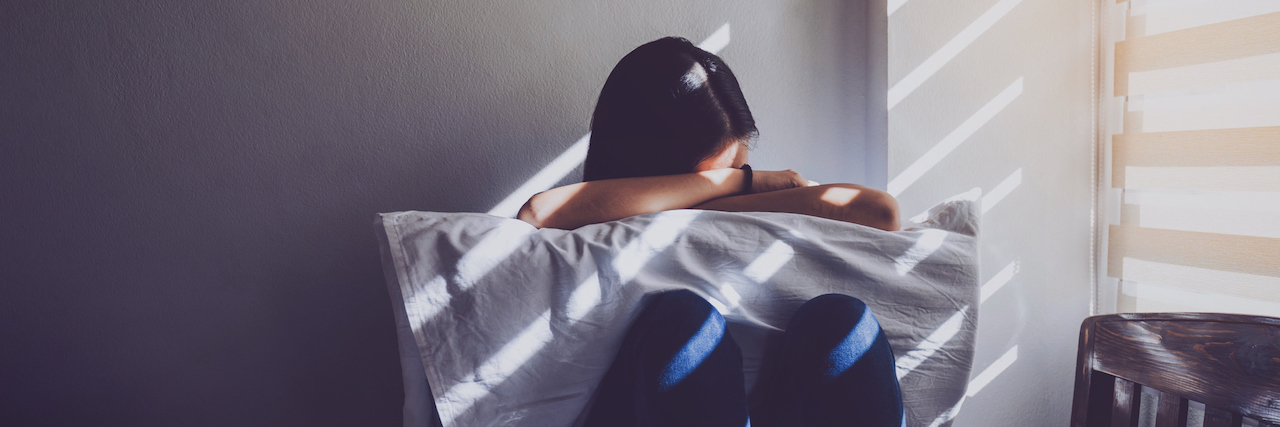 Learning About Myself After Leaving an Abusive Relationship Woman hugging a pillow