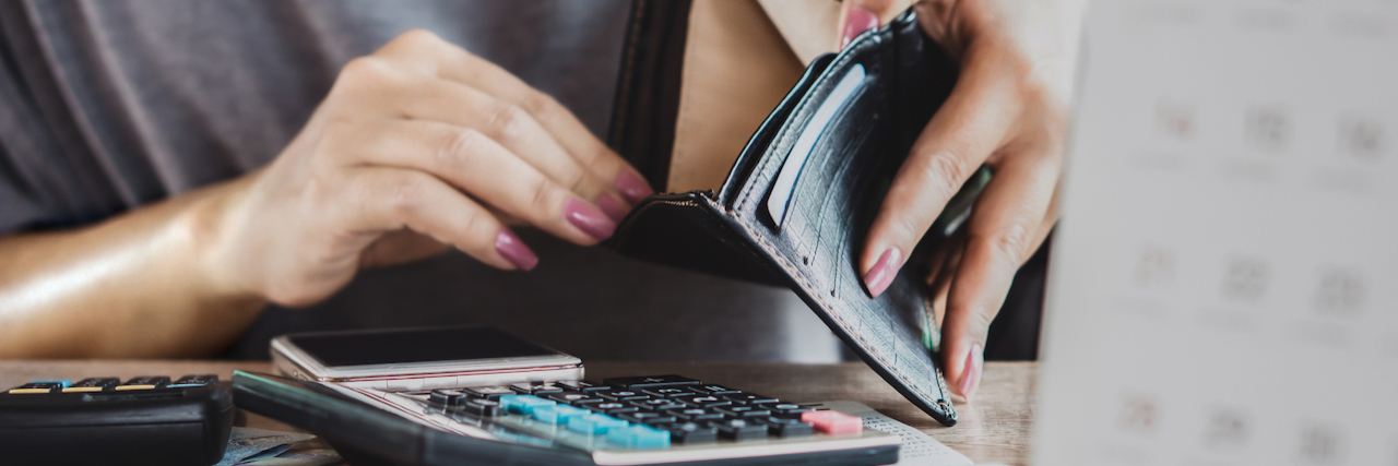 woman hand open empty purse looking for money for credit card debt, bankrupt concept