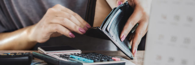 woman hand open empty purse looking for money for credit card debt, bankrupt concept