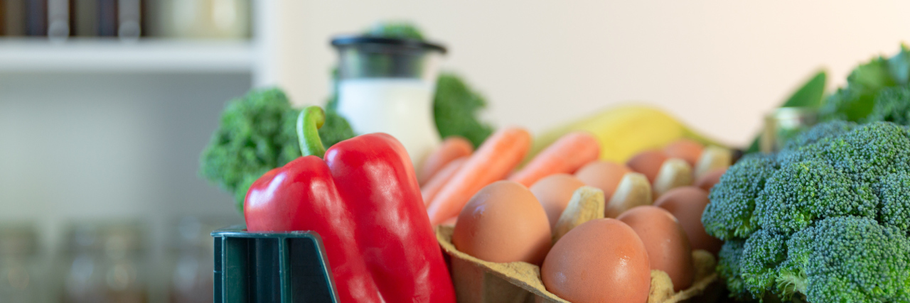 Chain Restaurants You Can Buy Groceries From During COVID-19 Fresh healthy groceries and vegetables from supermarket in green tray box. Food delivery service