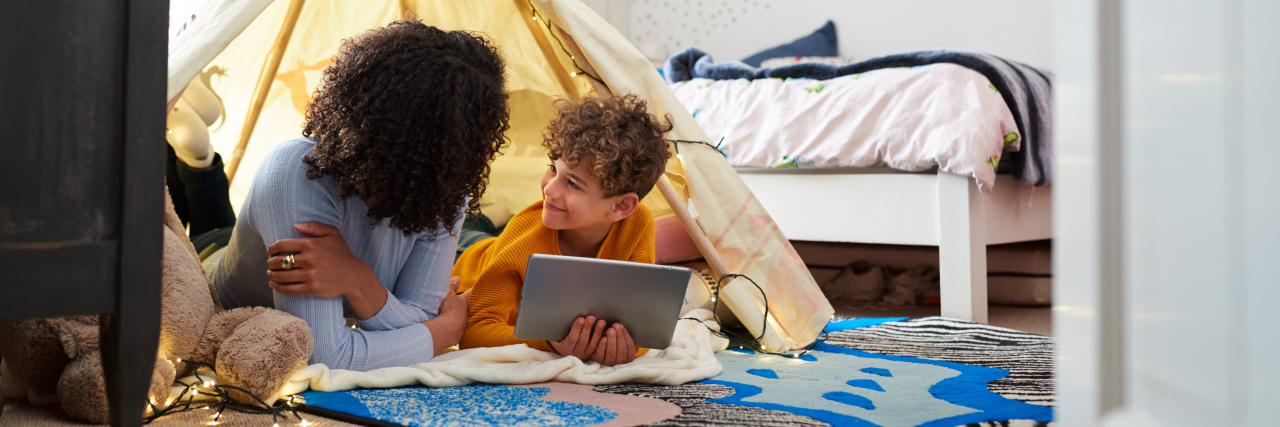 What People With Autism Can Teach You During the Coronavirus Pandemic Mother playing with son in tent.