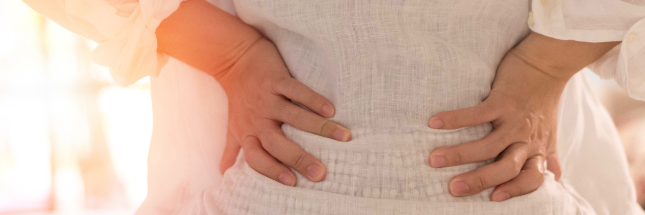 Getting a New Diagnosis of Degenerative Disc Disease Woman with back pain.