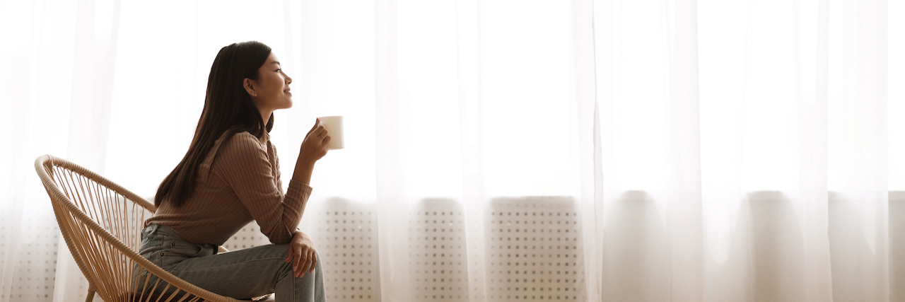 Woman relaxing in chair with coffee cup