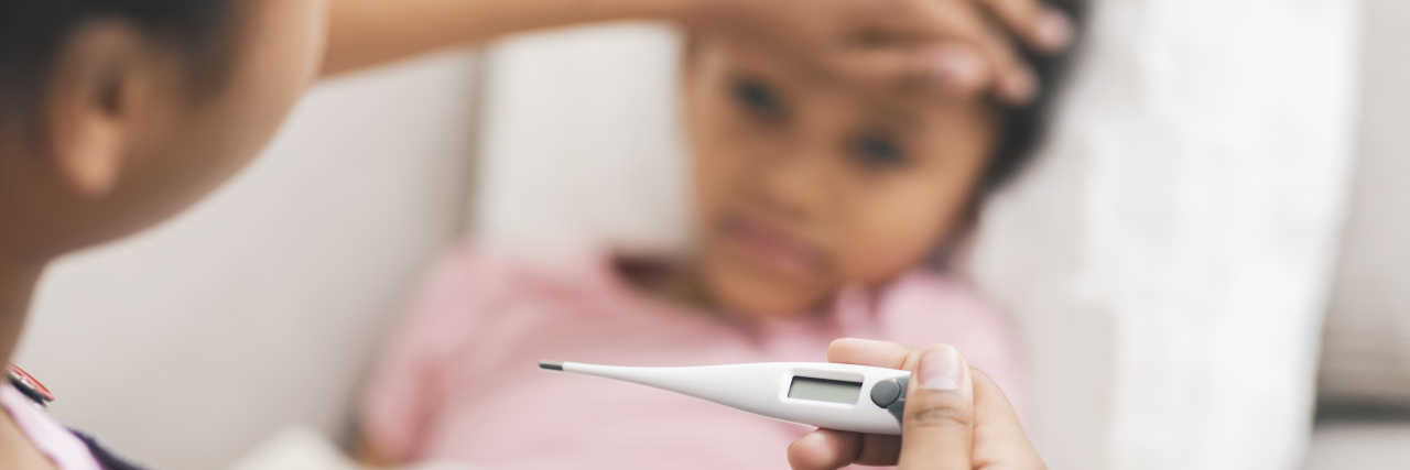 Why Personal Stories Matter More Than Numbers During COVID-19 Taking child's temperature with thermometer.