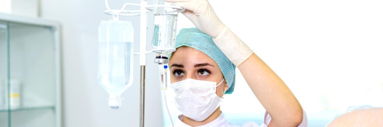 Staying Safe During COVID-19 If You Need Home Care Due to a Disability Nurse preparing IV infusion.