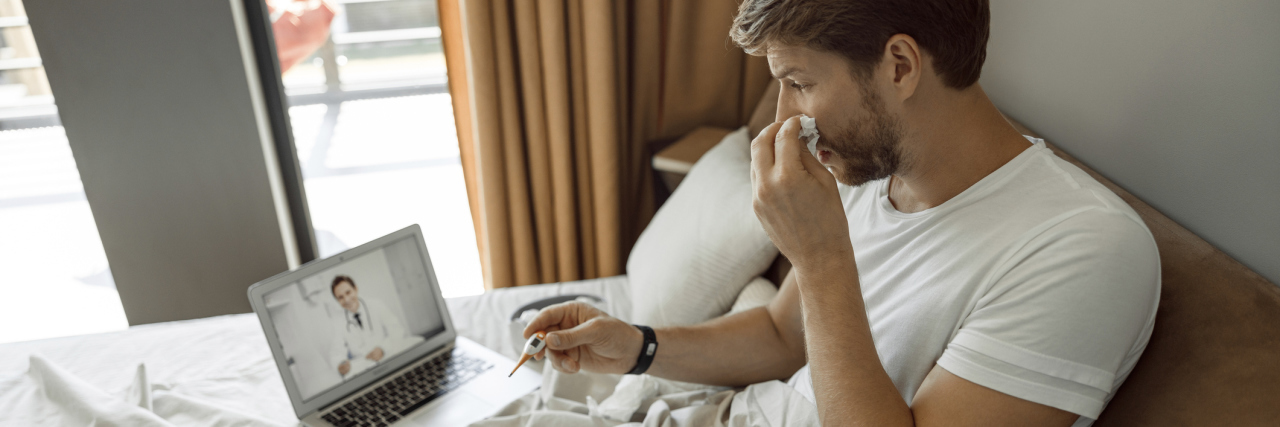 Telemedicine Surges From Coronavirus Fears and Insurance Changes Sick young Man making a video call to his doctor
