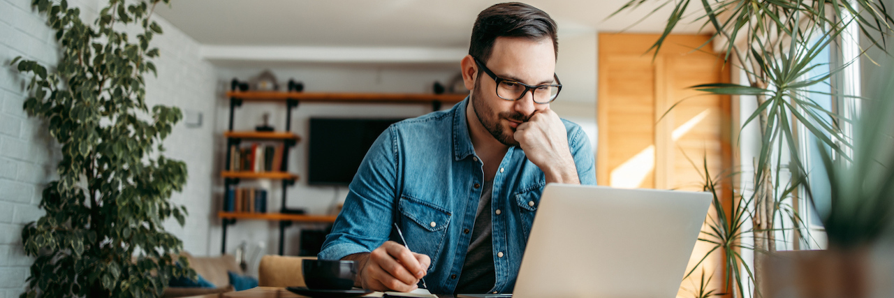 Find Emerging Information on COVID-19's Impact on Your Rare Disease Man looking at laptop and taking notes