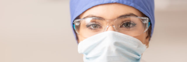 Portrait of female doctor in special surgical sterile protective clothing.