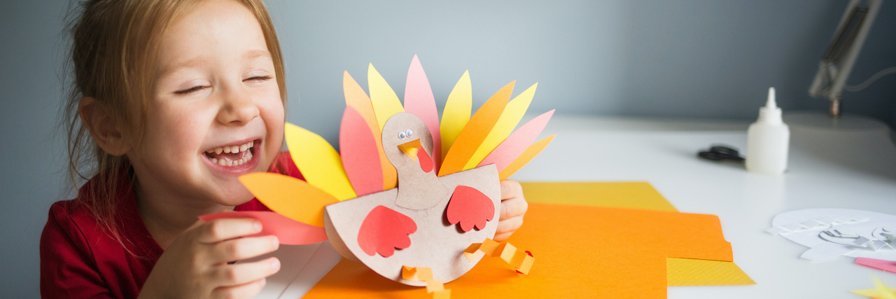 Craft Ideas for Kids Stuck in Quarantine A young girl with a craft turkey
