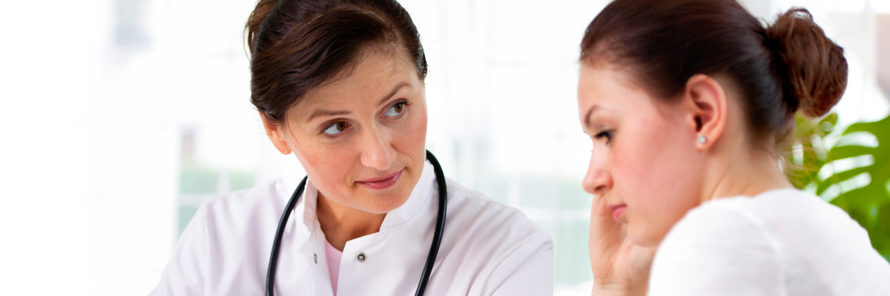 female doctor looking at patient who is looking away