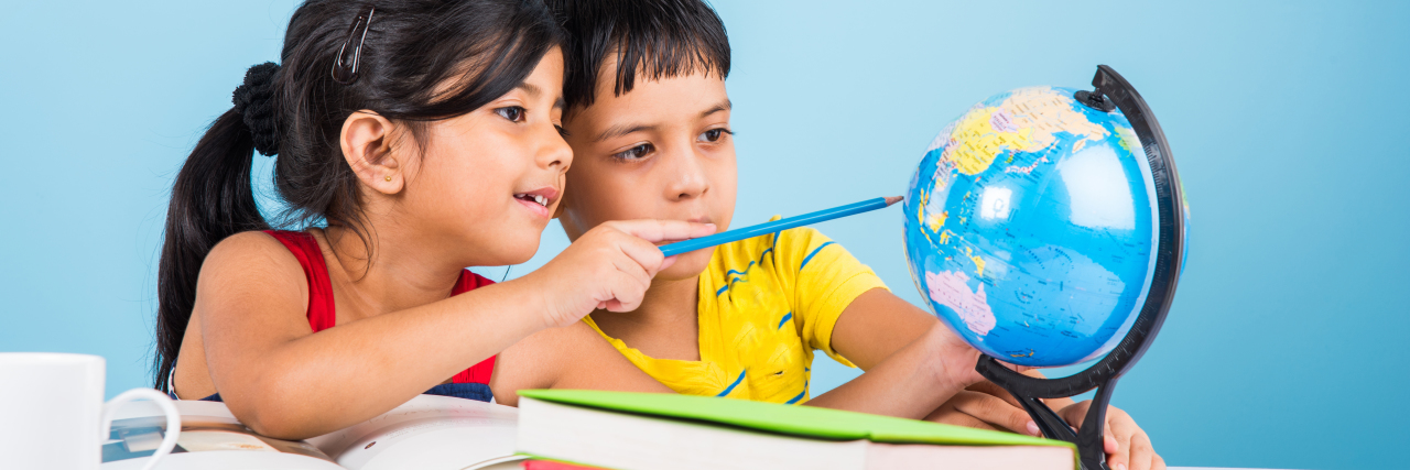 How Many Schools in India Discriminate Against Children With Autism Indian boy and girl studying with globe.