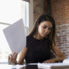 Businesswoman making notes on document