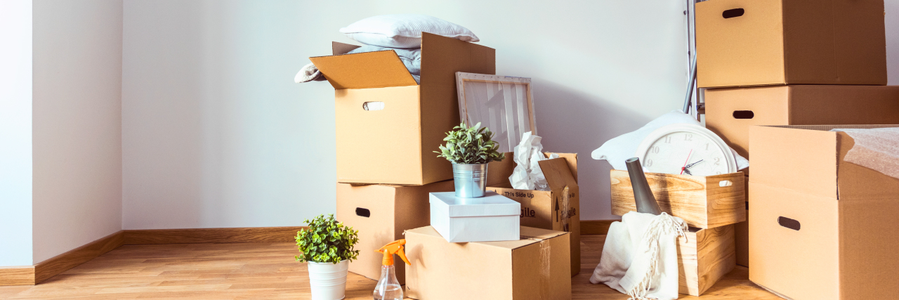 Getting My First Apartment as a Young Adult With Cerebral Palsy Apartment full of cardboard boxes, moving in to a new home with a disability.