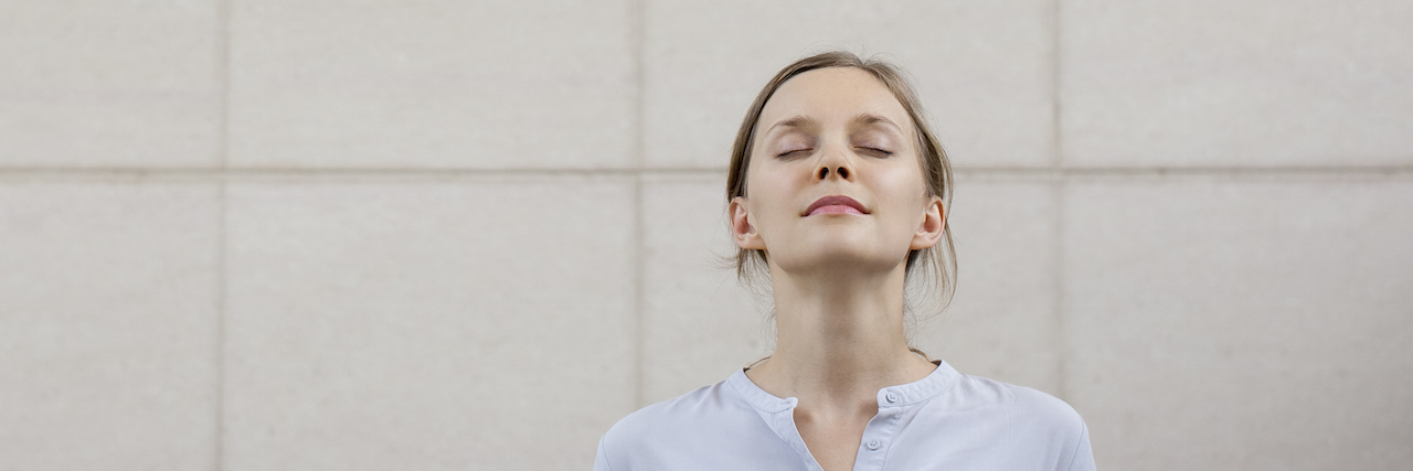Giving Up Perfection to Find My Balance With Chronic Illness Relaxed woman with eyes closed