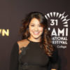 Gina_Rodriguez poses on the red carpet in a black ensemble