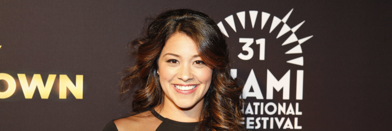 Gina_Rodriguez poses on the red carpet in a black ensemble