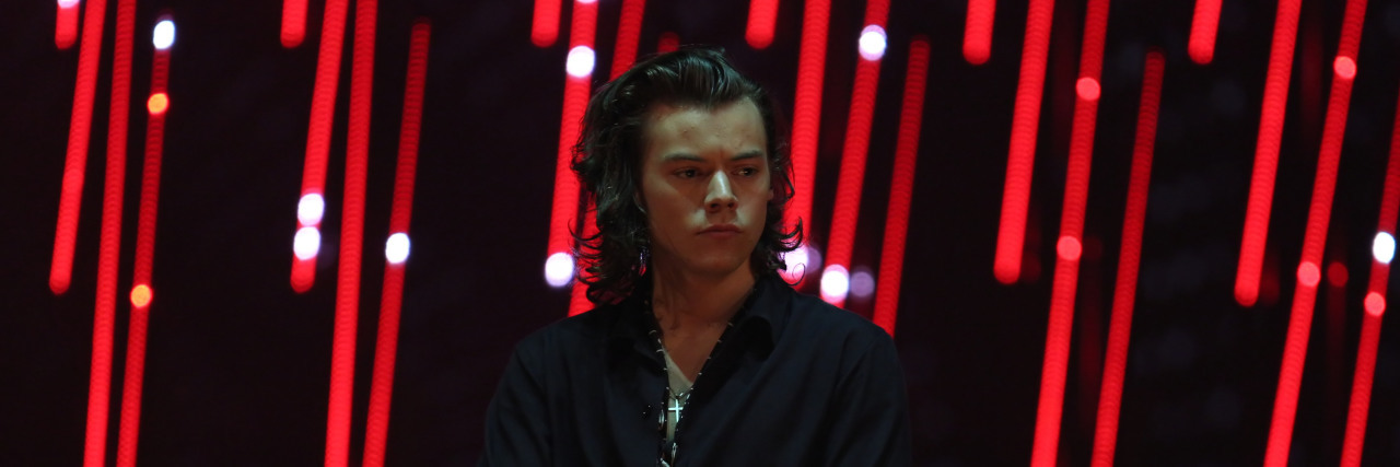 Harry Styles’ Merchandise Backlash, Fat Shaming, and Eating Disorders Harry Styles at a concert