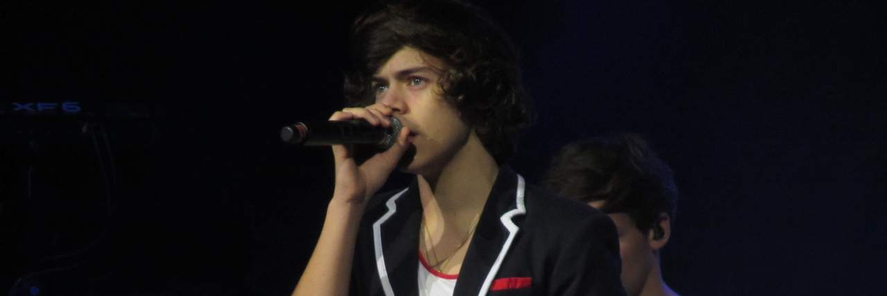 Harry Styles singing onstage