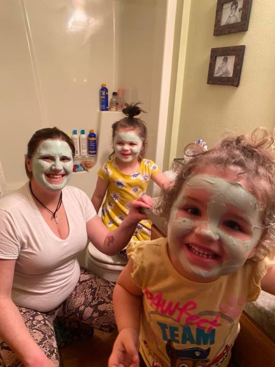 mother with daughters wearing spa face masks
