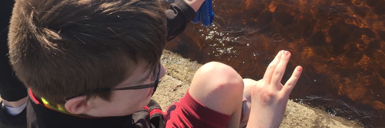 Why the COVID-19 Life Changes Are Hard for My Brother With Autism Dian playing by the water.