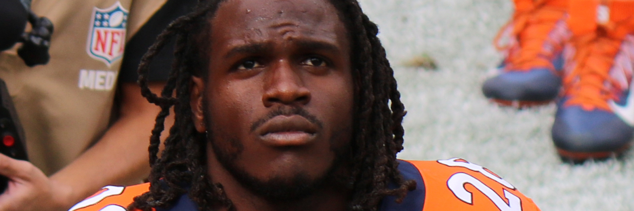 Jamaal Charles in a Broncos uniform on the sidelines of a football game