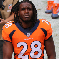 Jamaal Charles in a Broncos uniform on the sidelines of a football game
