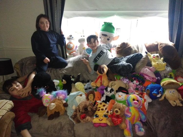 three kids surrounded by teddy bears