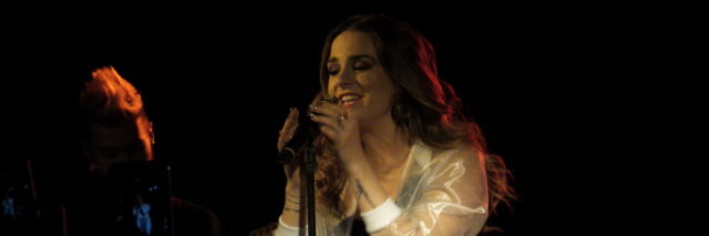 JoJo in a see-through top performs onstage.