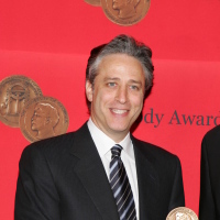 Jon Stewart backstage at the Peabody Awards holding an award