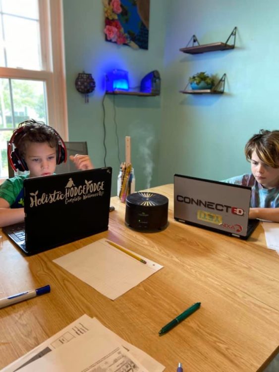 two kids working on laptops
