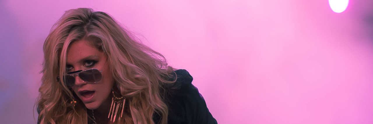 Kesha Talks About Suicidal Thoughts and 'Praying' With Sirius XM Kesha performs in a black outfit in front of pink mist