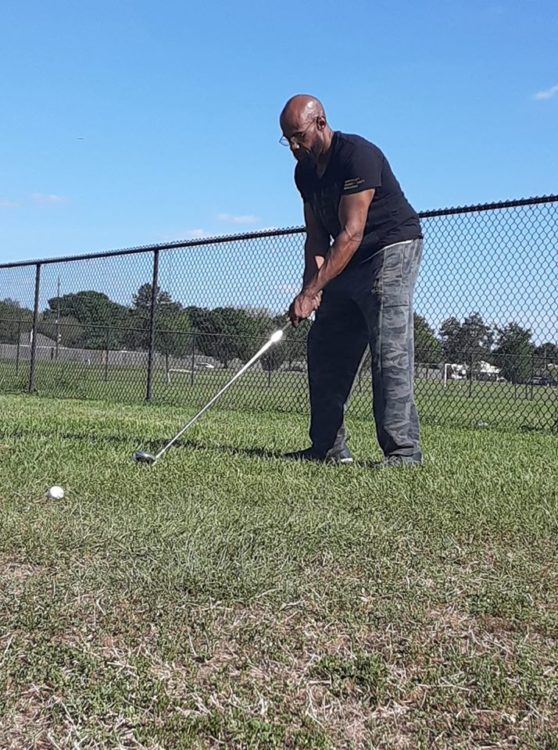 man playing golf in deserted park