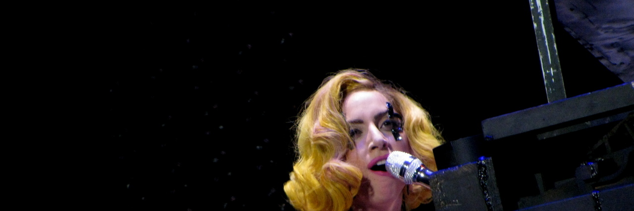 Lady Gaga sings in front of a pinao