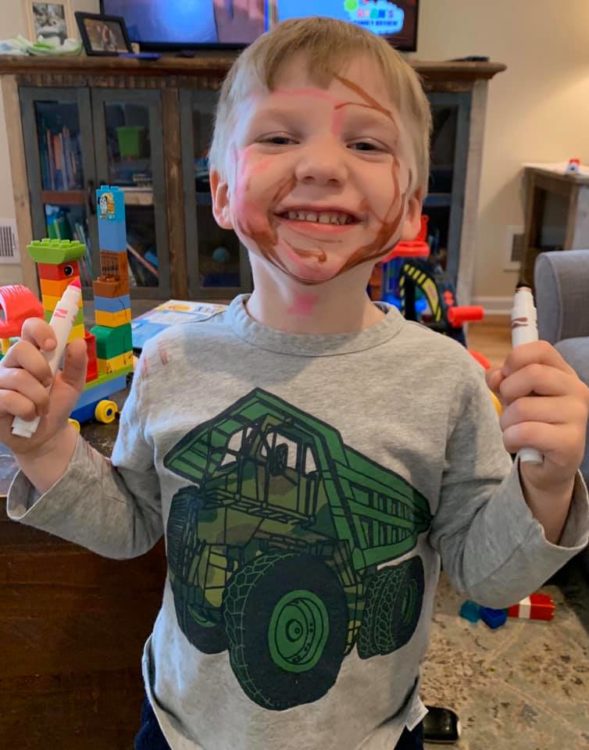 little boy with marker all over face