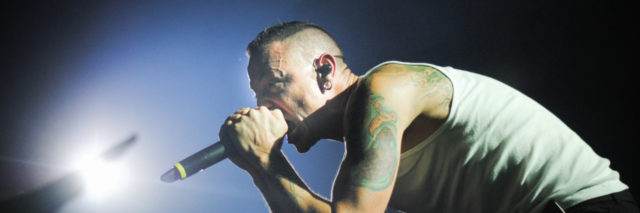 Chester Bennington singing into the audience at a concert