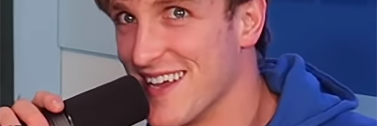 Logan Paul's New Video Is About Suicide Prevention Logan Paul speaks into the microphone while at a radio show