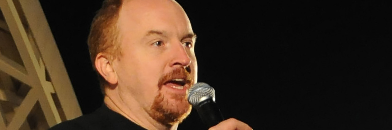 Louis C.K. performing at an event.